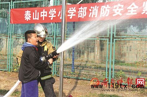 泰山中學(xué)小學(xué)部學(xué)生體驗(yàn)滅火。本報記者 白雪 攝